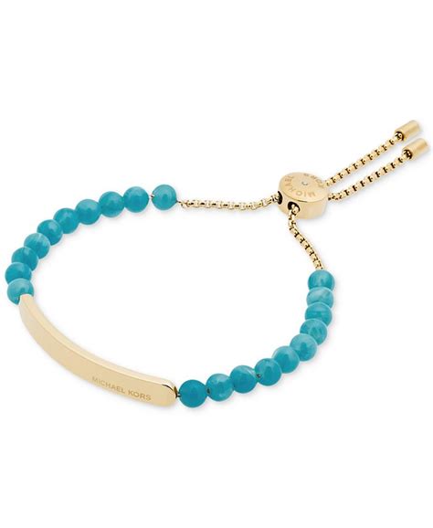 michael kors gold tone blue bead logo plaque slider bracelet